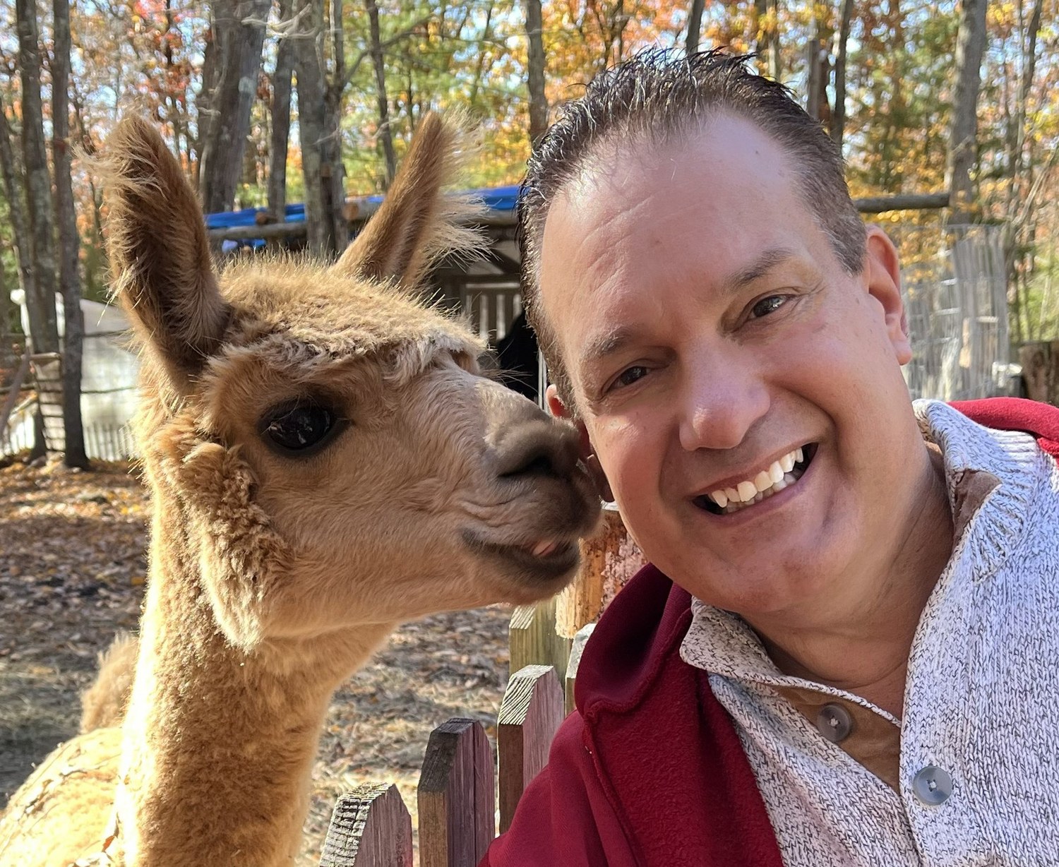 Kevin Cordeiro with Hermey the Alpaca outdoors